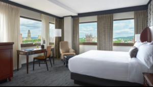 Hotel corner room with one bed.