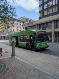 Green shuttle bus from New Haven Union Station to Downtown New Haven, stopped at the corner of Chapel and Church Streets.